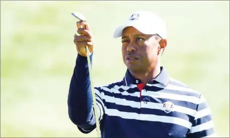  ?? ERIC FEFERBERG/AFP ?? Tiger Woods checks his club during a practice session ahead of the 42nd Ryder Cup at Le Golf National Course at Saint-Quentin-en-Yvelines, southwest of Paris on, on Wednesday.