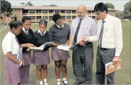  ??  ?? Principal Yugan Naidoo, second right, and acting deputy principal Ashok Kumar Roopnarain, with pupils Liyabona Nyathi, Nosipho Biyase, Zama Cele and Samkelisiw­e Naki.