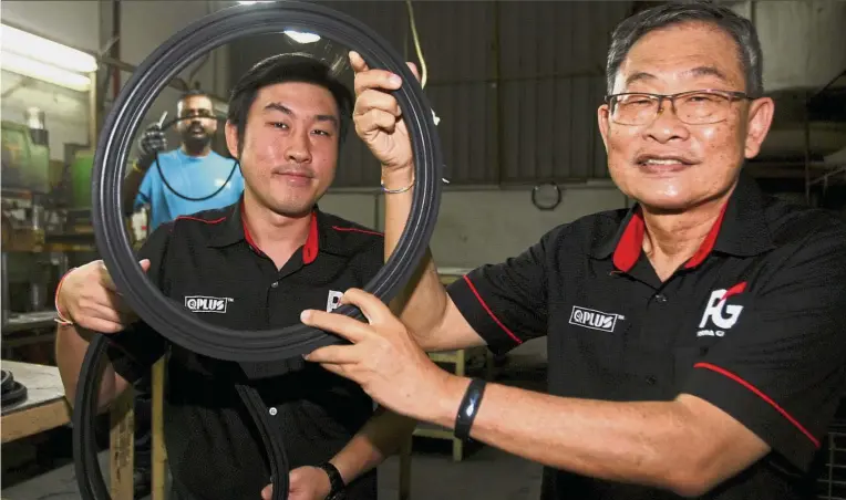  ??  ?? Different products: Chuan Yuan (left) and Ong showing off some of the rubber products for industrial use.