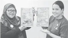  ??  ?? Eneng Faridah (left) with MCMC’s senior staff, Siti Farahdina Basheer showing the poster of ‘Klik Dengan Bijak’ (Click Wisely) programme. — Bernama photo