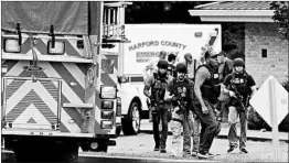  ?? MATT BUTTON/BALTIMORE SUN ?? A group of ATF police makes its way to the shooting scene in northeaste­rn Maryland.