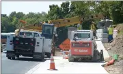  ?? NWA Democrat-Gazette/ANDY SHUPE ?? Fayettevil­le Transporta­tion Division workers assemble a retaining wall Thursday along College Avenue. The city has begun hiring an artist to create a mural on the retaining wall between Cleburn and Prospect streets to be completed by the first of...