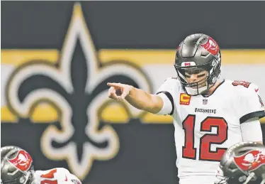  ?? PHOTOS BY BRYNN ANDERSON/ASSOCIATED PRESS ?? Tampa Bay Bucs quarterbac­k Tom Brady signals at the line of scrimmage Sunday against the Saints in New Orleans.