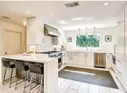  ??  ?? The gourmet kitchen features Silestone countertop­s and high-end stainless steel appliances.