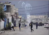  ?? (Ap/majdi Mohammed) ?? Palestinia­ns run from tear gas fired by Israeli forces while they raid Aqbat Jabr camp, southwest of the city of Jericho, on Saturday.