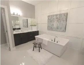  ??  ?? The master ensuite in the Cash & Cars Lottery Edmonton dream home has two separate vanities with quartz counters, undermount sinks and a free-standing soaker tub.