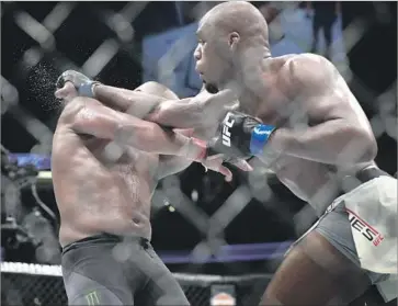  ?? Sean M. Haffey Getty Images ?? JON JONES goes on the attack against Daniel Cormier during Saturday night’s UFC light-heavyweigh­t bout at Honda Center. “It feels unbelievab­le. It’s a surreal moment,” Jones said after his victory.