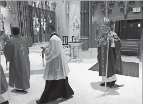  ?? JENNIFER MCDERMOTT/AP PHOTO ?? Providence diocese Bishop Thomas Tobin, right, enters during the procession­al at the Cathedral of Saints Peter and Paul in Providence, R.I., on Friday for a day of prayer and penance he called for due to the sex abuse scandal in the Roman Catholic Church.