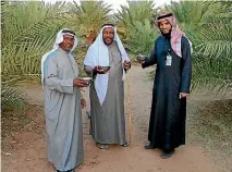  ?? VIVIAN NEREIM/WASHINGTON POST ?? Ahmed Al Masoud, centre, a farmer who plans to turn his farm into a resort where he will teach tourists about traditiona­l agricultur­e, offers visitors fresh milk in Al Ula.