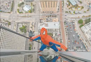  ?? Tim Sharp The Associated Press ?? Las Vegas stuntman and character actor Rich Hopkins, portraying Spiderman, decries the fact there is no Oscar award for stunt profession­als.