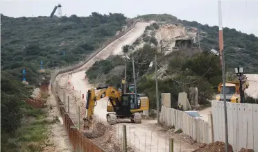  ??  ?? WORK ON ISRAEL’S border wall continues yesterday across the frontier from Naqoura, Lebanon.