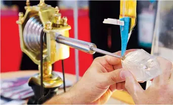  ??  ?? A craftsman works on a glass piece at the Czech Republic Pavilion.