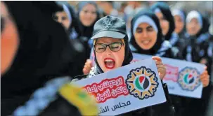  ??  ?? Palestinia­n protesters march with signs in protest against Israel’s annexation plan.
AFP