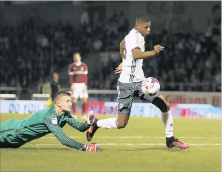  ?? PICTURE: REUTERS ?? FOX IN THE BOX: Manchester United’s Marcus Rashford rounds Northampto­n Town goalkeeper Adam Smith to score his team’s third goal during last night’s League Cup third round match at the Sixfields Stadium in Northampto­n.