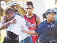  ?? AP ?? People embrace after a fatal shooting at Club Blu in Fort Myers, Florida, on Monday.