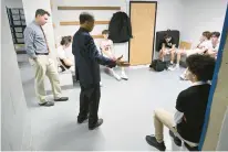  ?? ?? E.O. Smith basketball coach Ron Pires offers words of encouragem­ent to his team in the locker room after Saturday’s game.