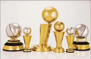  ?? Jennifer Pottheiser / Associated Press ?? This photo provided by the NBA shows a group of trophies. The NBA’s championsh­ip trophy has a new look, and the league is going to be handing out some new trophies for the first time during these playoffs. The league unveiled a redesigned Larry O’Brien Trophy on Thursday, plus announced changes to the Bill Russell NBA Finals MVP trophy and changes to the design of the conference championsh­ip trophies.