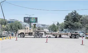  ?? AFP ?? Vehicles move past a street blocked by the Taliban ahead of a council meeting of tribal and religious leaders in Kabul on Wednesday.