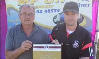  ??  ?? Pádraig Kelly of Menapians accepting the athlete of the month award for February from Paddy Morgan (Co. Chairman) on behalf of Leon Reid at the county championsh­ips last week.