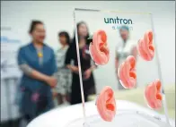  ?? REN ZHENGLAI / XINHUA ?? Visitors take a look at hearing aid products at Sonova Global Hearing Institute, launched in Suzhou on May 5.