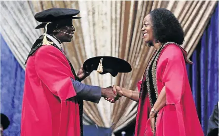  ?? /ALAISTER RUSSELL ?? Former deputy chief justice and Wits University chancellor Dikgang Moseneke congratula­tes his successor, Dr Judy Dlamini, during her inaurgurat­ion on Saturday.