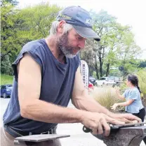  ?? PHOTO: JACK CONROY ?? Custom shaping . . . SPO Shoeing operator Phil Swanson demonstrat­es farrier’s skills at the Lawrence Heritage Festival on Sunday.