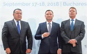  ??  ?? Polish President Andrzej Duda, center, Romanian counterpar­t Klaus Iohannis, right, and the head of Romania’s Chamber of Commerce and Industry attend the opening Monday of the Three Seas Initiative in Bucharest, Romania. ANDREEA ALEXANDRU/AP