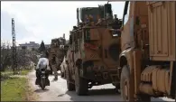  ?? (AP/Ghaith Alsayed) ?? A Turkish military convoy stops Saturday in Syria’s Idlib province. Turkey has sent thousands of troops into the province in recent weeks.