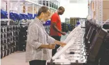  ?? ASSOCIATED PRESS FILE PHOTO ?? Employees of the Fulton County Election Preparatio­n Center in Atlanta test electronic voting machines in 2016.