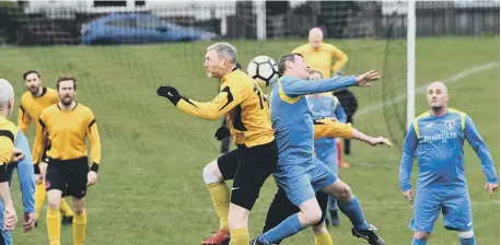  ??  ?? Sunderland Ivy Legends Over-40s (yellow) and Pennywell Comrades battle it out in an aerial duel in the Division Three clash.