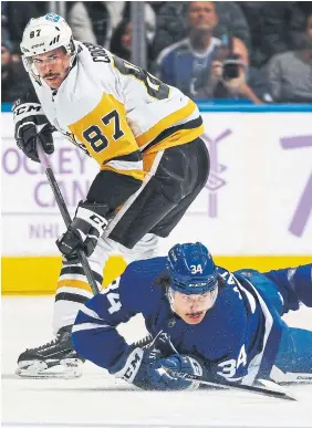  ?? CLAUS ANDERSEN GETTY IMAGES ?? Penguins centre Sidney Crosby and Auston Matthews of the Leafs tangle in Saturday night’s game at Scotiabank Arena.