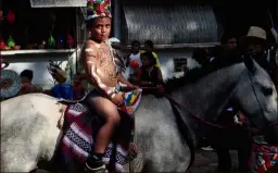  ??  ?? Nicaragua: A child dressed in indigenous attire riding a horse during a parade to commemorat­e Indigenous Resistance Day in San Juan de Oriente. — Reuters