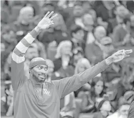  ?? Rich Pedroncell­i / Associated Press ?? Rockets forward Corey Brewer celebrates on the bench after teammate Trevor Ariza converted a 3-pointer against the Kings during the first quarter Friday.