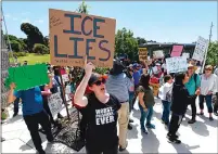  ??  ?? Mimi Main, of San Francisco, raises a sign as she chants slogans towards the main entrance of the West County Detention Facility in Richmond on Sunday.