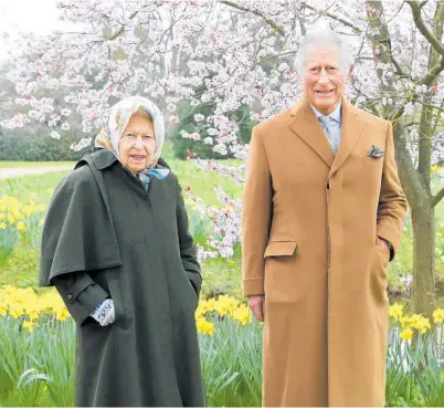  ?? Photo / Getty Images ?? The Queen and Prince Charles stroll through the garden at Frogmore House.