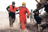  ??  ?? Firefighte­rs and police are forced to flee from a search and rescue effort as the Volcan de Fuego, or Volcano of Fire, continues to spill out smoke and ash in Escuintla, Guatemala.