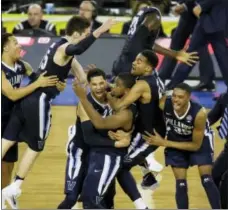  ?? CHARLIE NEIBERGALL — THE ASSOCIATED PRESS ?? Villanova players celebrates after Kris Jenkins, center, scores a game winning three point basket in the closing seconds of the NCAA championsh­ip game in Houston.