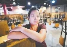  ?? DAN JANISSE ?? Danielle Nowak, a server at Cramdon’s Tap and Eatery on Dougall Avenue, has seen her hours drasticall­y cut.