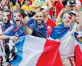  ?? JON SUPER/The Associated Press ?? Enthusiast­ic French supporters party before the Group E World Cup soccer match between
France and Honduras at the Estadio Beira-Rio on Sunday in Porto Alegre, Brazil.