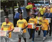  ?? Godofredo A. Vasquez / Houston Chronicle file ?? Houston firefighte­rs last July collected boxes filled with more than 32,000 signatures to put equal pay on the ballot. A referendum has yet to take place.