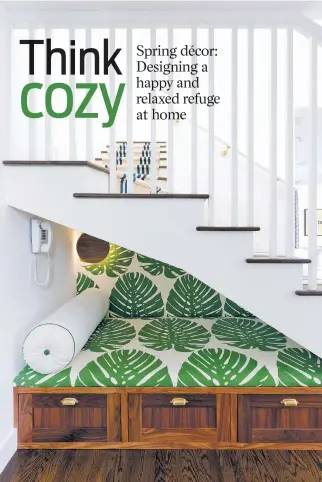  ?? AMY BARTLAM/AMY SKLAR DESIGN VIA AP ?? Designer Amy Sklar tucked a smartly decorated nook under these stairs — the perfect little hideaway for reading or a quiet phone chat. The fabric, by Raoul Textiles, is called Elephant Leaf. Sklar had it backed to use as wallpaper as well.