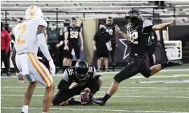  ?? GEORGE WALKER IV The Tennessean via AP ?? Vanderbilt placekicke­r Sarah Fuller kicks an extra point during the first quarter Saturday, becoming the first woman to score points in an NCAA college football game.