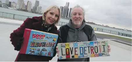  ?? JASON KRYK ?? Elaine Weeks and Chris Edwards pose on the Windsor waterfront with their newly published book, called 5000 Ways You Know You’re From Detroit, packed with photos and research that pays tribute to the Motor City’s baby boomer years.