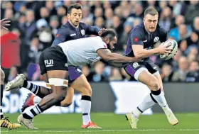  ??  ?? Slipping free: Stuart Hogg dodges a tackle as he looks to spark a Scotland attack