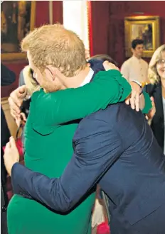  ??  ?? Prince charming: Bryony Gordon gets a hug from Prince Harry at the palace reception