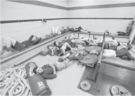  ?? Thomas B. Shea ?? While waiting to play Friendswoo­d, Deer Park baseball players staged an impromptu slumber party in their locker room during a rain delay.