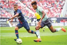  ?? AFP ?? Paris Saint-Germain’s Colin Dagba (left) vies for the ball with Bayern Munich’s Kingsley Coman in Klagenfurt, Austria.