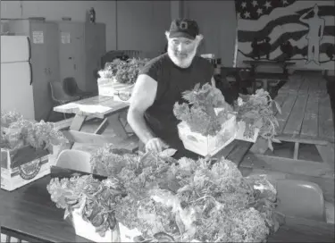  ?? Photos by Andrew Cass/ACass@News-Herald.com ?? Geauga Family Farms driver John Egan prepares shares of produce for pick up at the Lake County Histor y Center. Through its subscripti­on-based Community Supported Agricultur­e program, Geauga Family Farms provides shares of its produce in five counties...