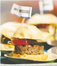  ?? PATRICK T. FALLON / BLOOMBERG FILES ?? Impossible Foods is dropping prices by an average of 15 per cent for distributo­rs in the U.S., making the lowest
price for its burger product US$6.80 per pound.