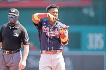  ?? Ap-alex Brandon ?? Atlanta Braves’ Ronald Acuna Jr. celebrates his double during the first inning in the first baseball game of a doublehead­er against the Washington Nationals at Nationals Park on in Washington April 7.